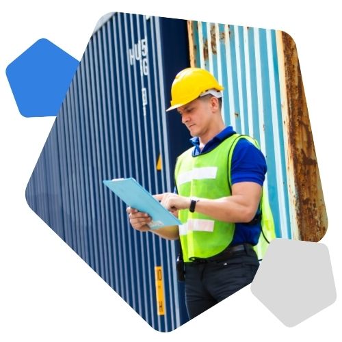 Man in hard hat and high vis standing outside storage unit
